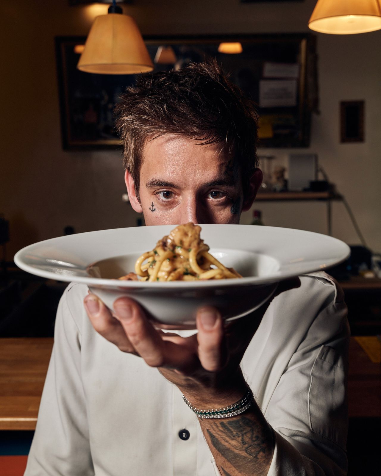 Editorial portrait chef holding pasta dish restaurant — Thomas Habr commercial photographer