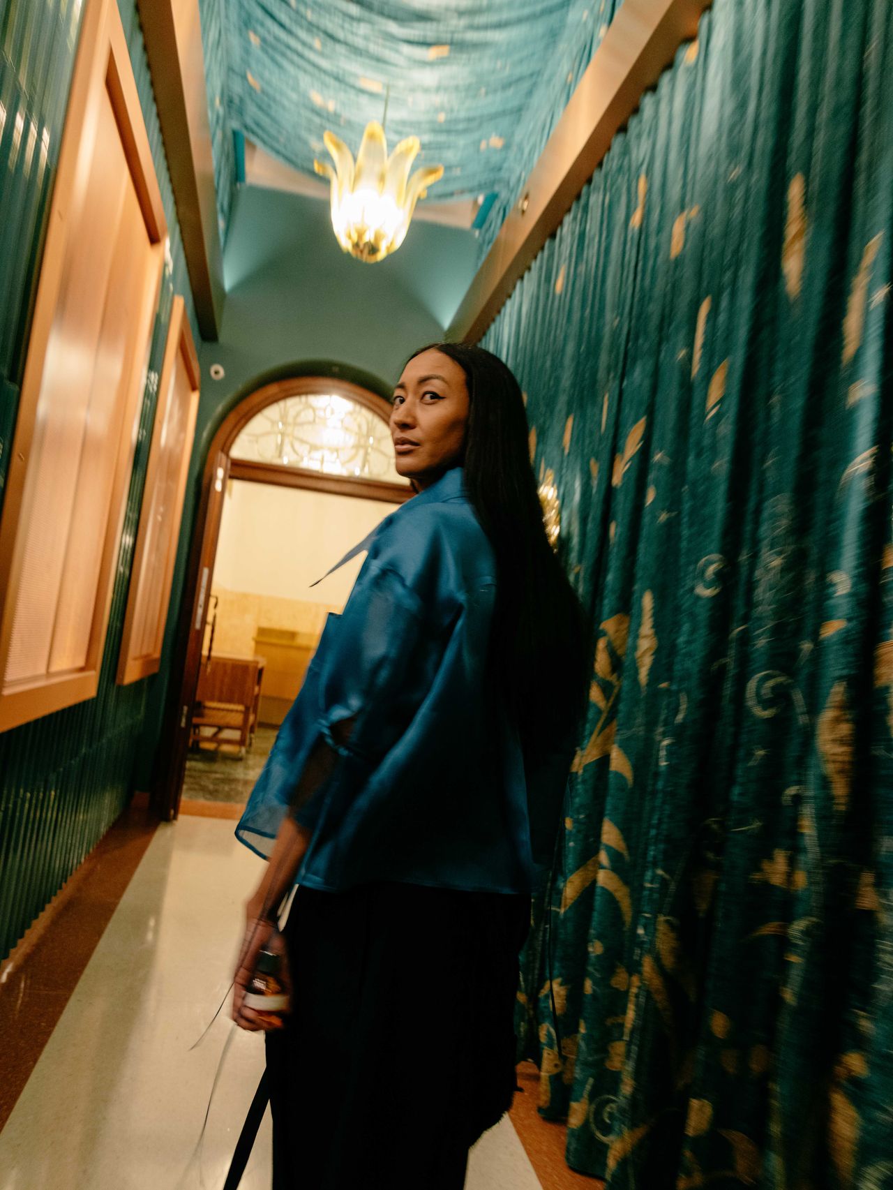 Fashion editorial woman in blue leather jacket ornate gold hallway — Thomas Habr photographer