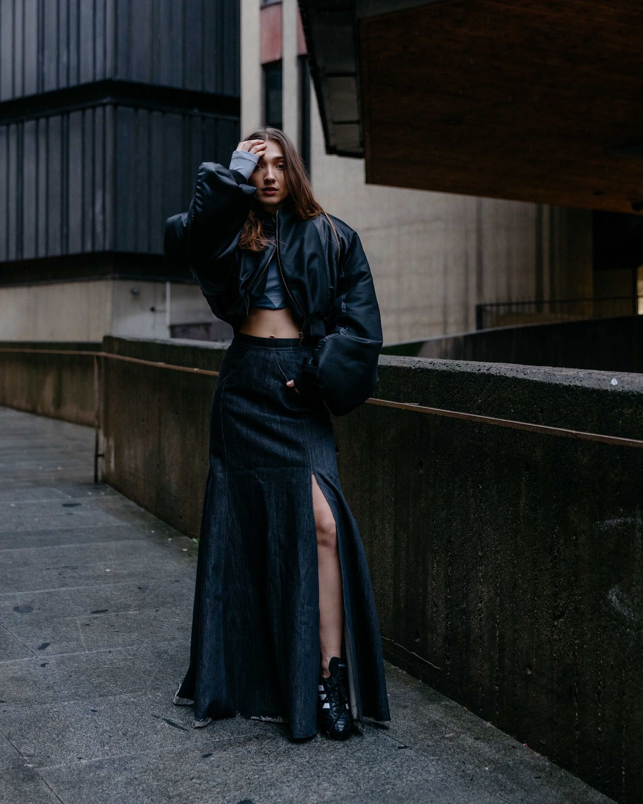 Dark urban fashion editorial woman in long black coat — Thomas Habr fashion photographer Prague
