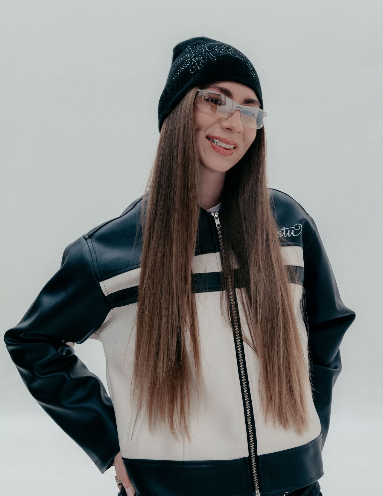 Streetwear fashion editorial woman in racer jacket and beanie long hair — Thomas Habr commercial photographer