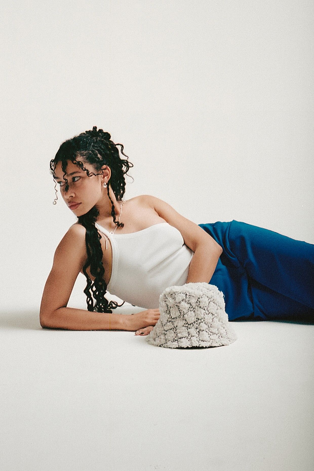 Via Concept Store fashion editorial campaign model lying down white top blue skirt — Thomas Habr fashion photographer