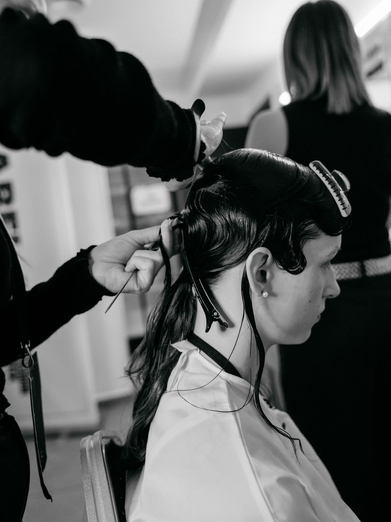 Black and white fashion week backstage photography hairdresser styling model — Thomas Habr photographer