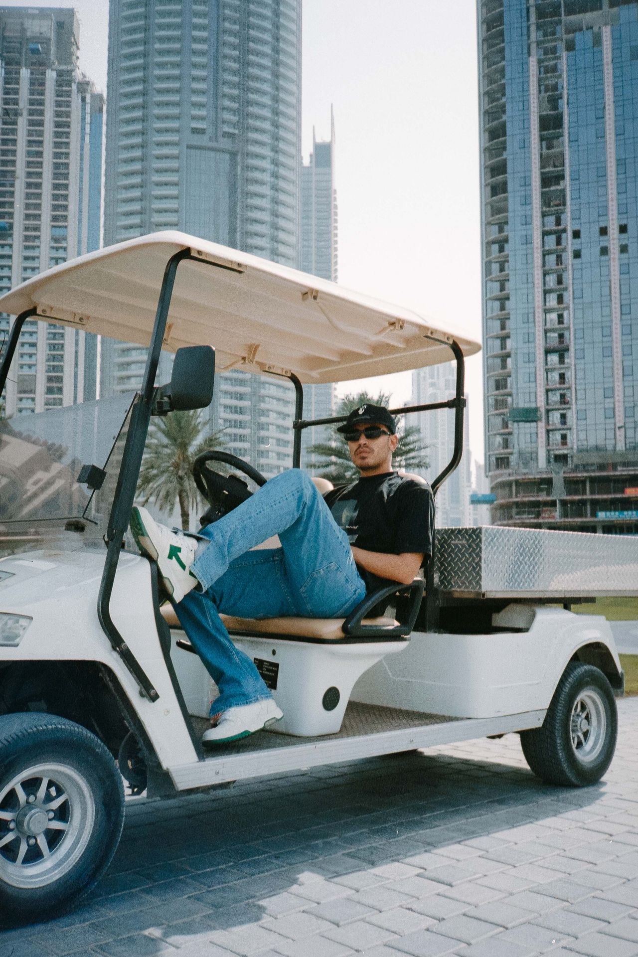Lifestyle editorial man on golf cart Dubai skyline — Thomas Habr international photographer