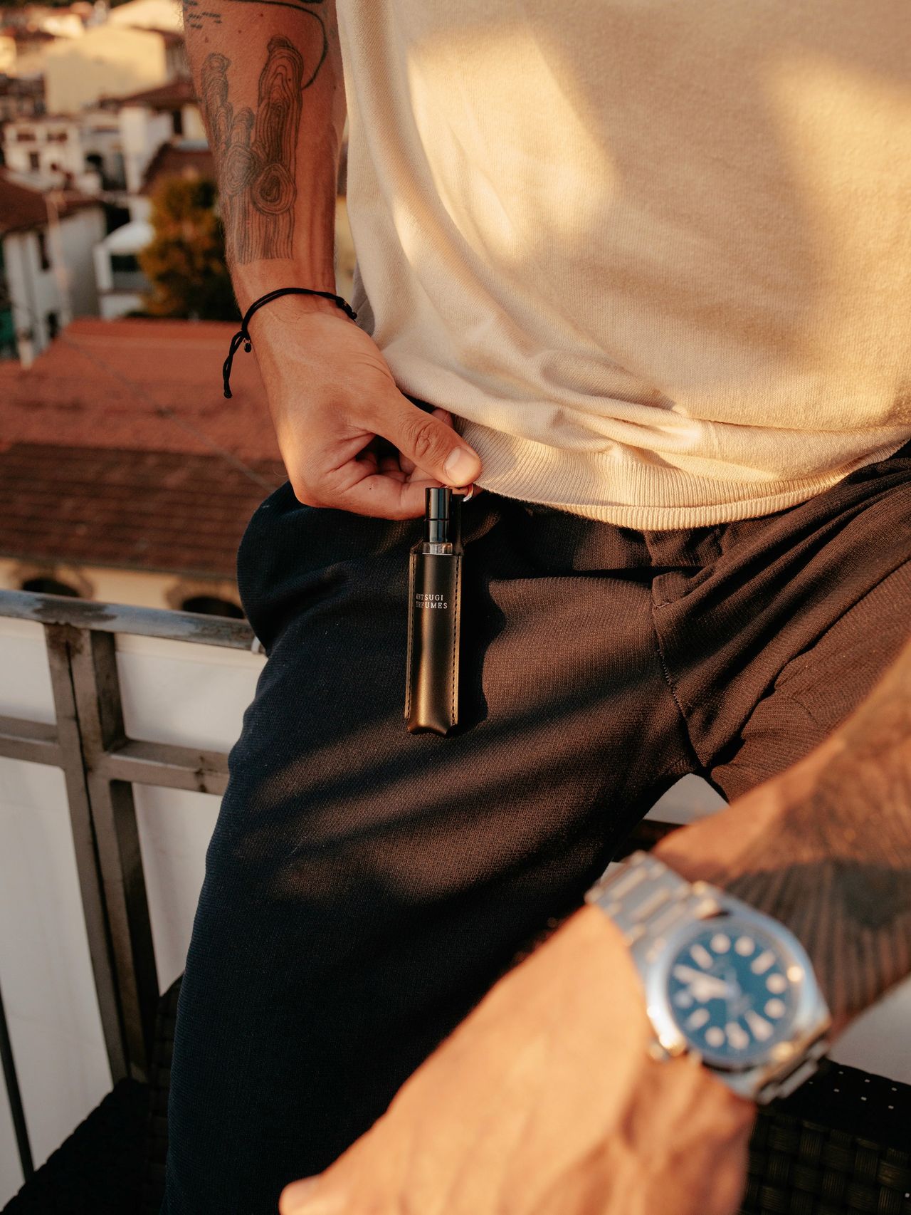 Lifestyle brand campaign man holding Kintsugi Perfumes fragrance and luxury watch — Thomas Habr commercial photographer