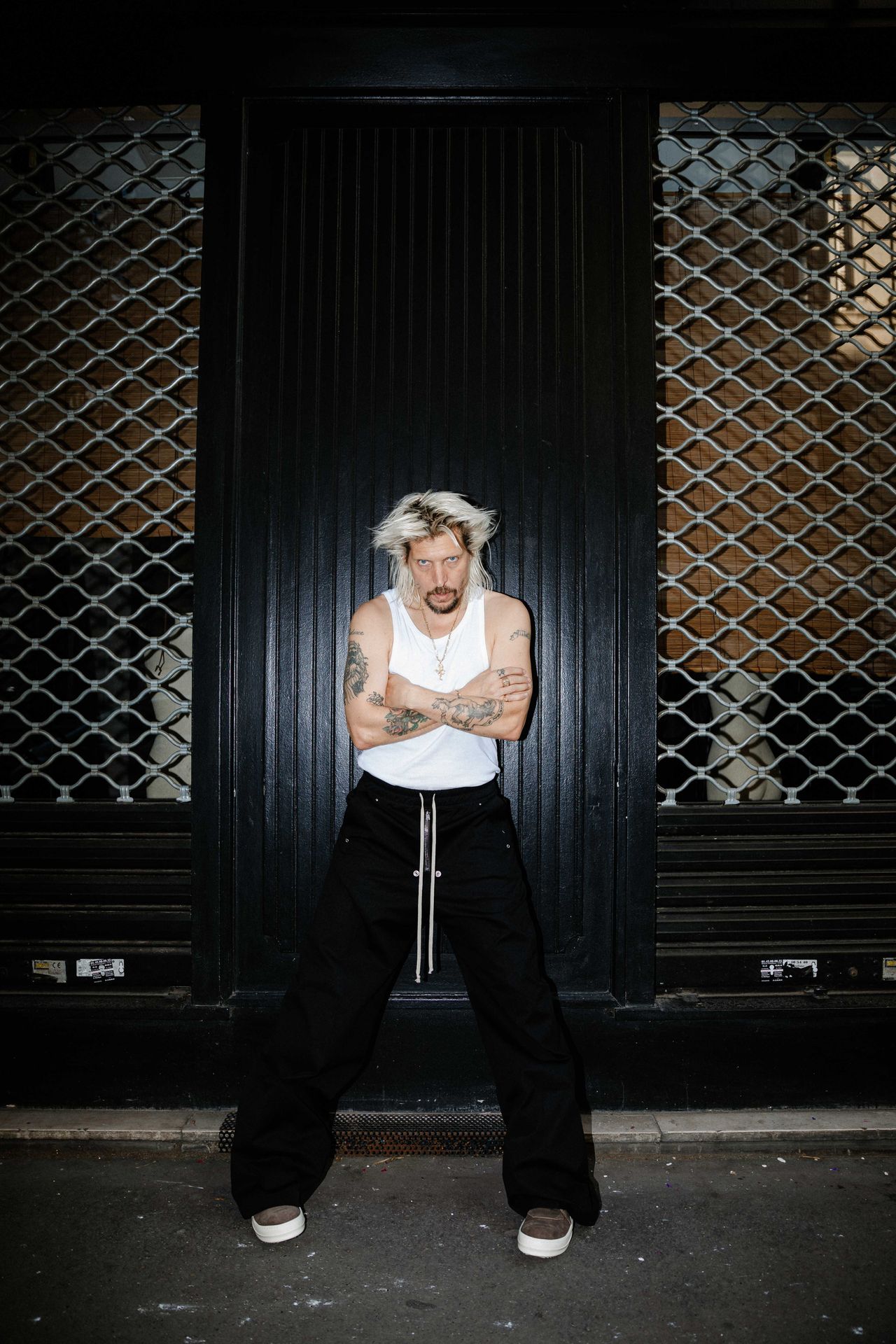 Skateboarder portrait standing in front of ornate black door — Thomas Habr Prague